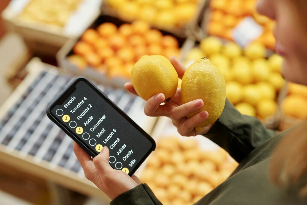 Woman looking at grocery shopping list at the supermarket