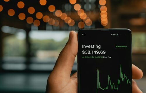 Person using stock market investing app on smartphone